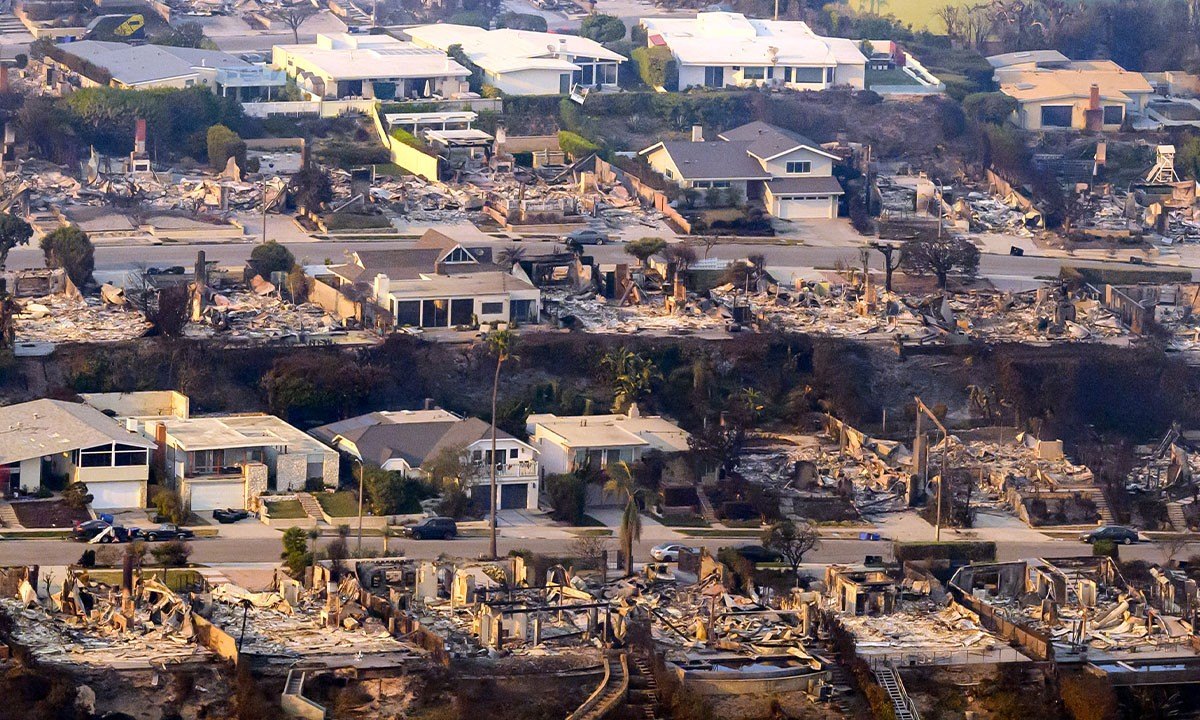 In this aerial view taken from a helicopter, burned homes are seen from above during the Palisades fire in Los Angeles county, California