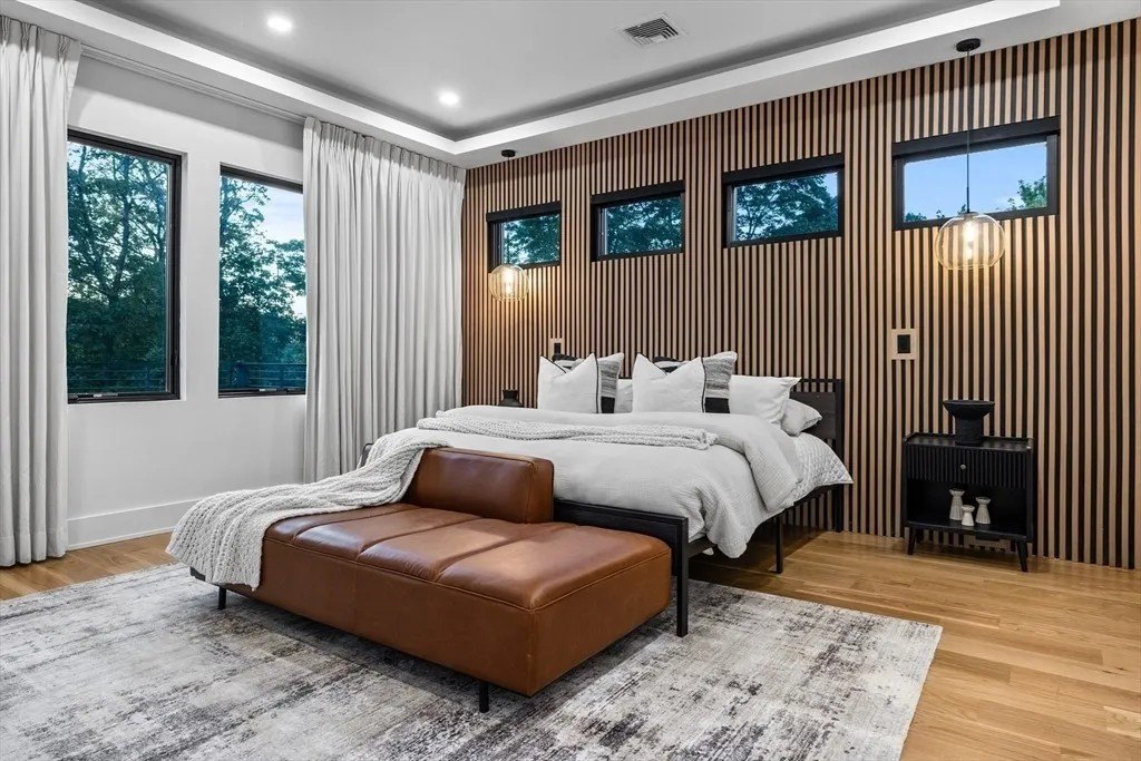 NBA Star Jrue Holiday Lists His Massachusetts Home For $6.9 Million—Weeks After Portland Trail Blazers Bedroom with detailed wall in a luxury home in Massachusetts that belongs to Jrue Holiday
